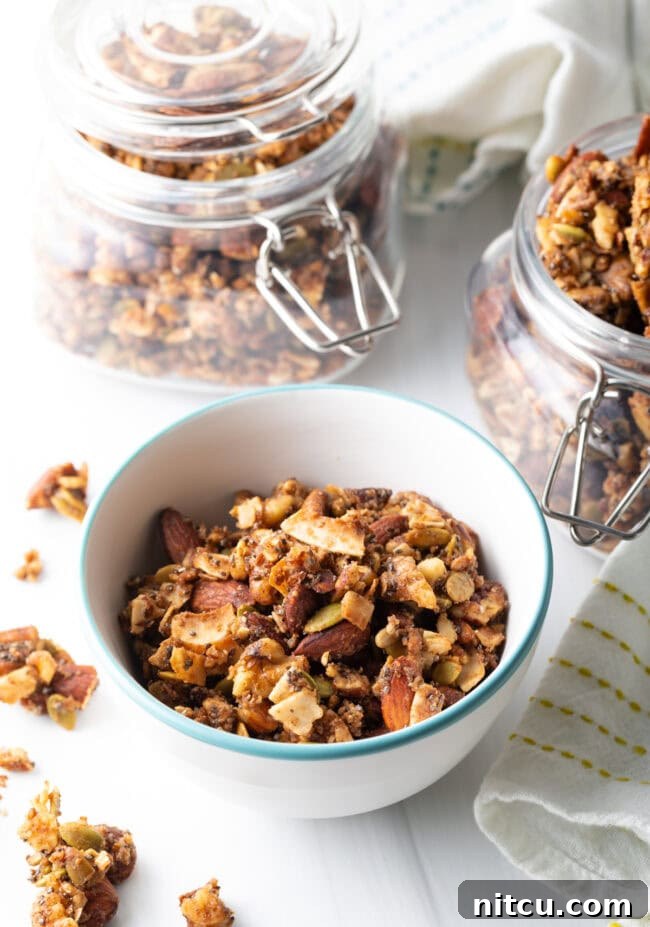 Top view of a white bowl filled with homemade keto granola, showing its rich texture.