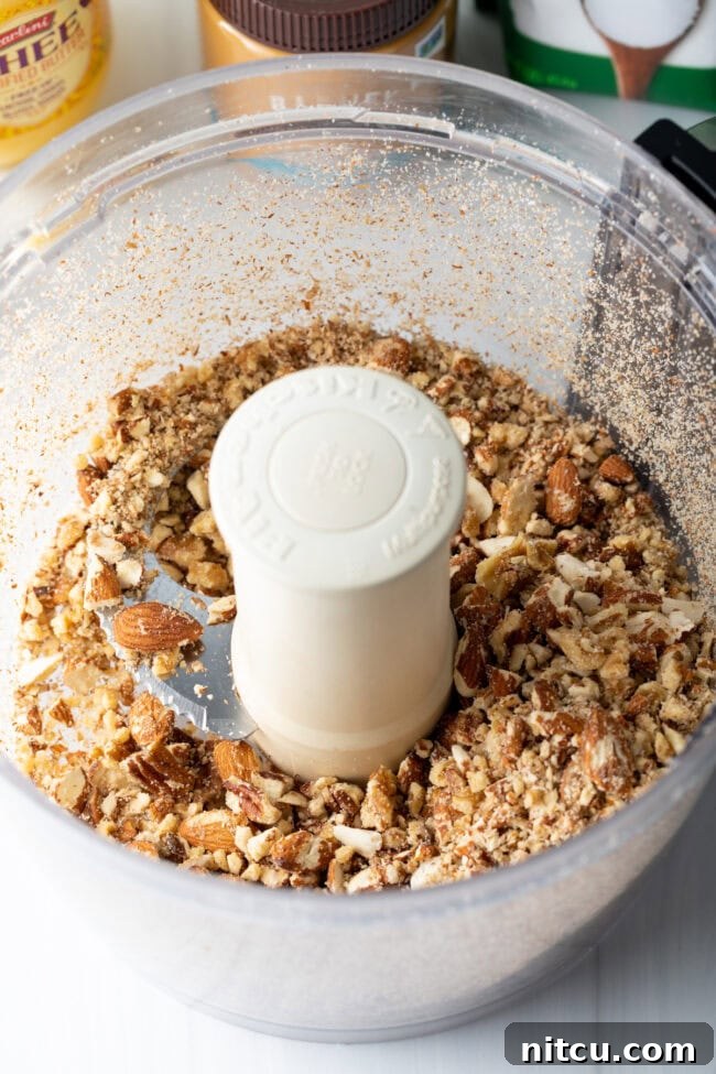 Close-up of mixed nuts and seeds in a large mixing bowl.