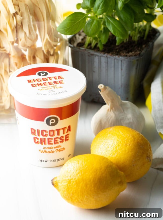 Ingredients needed: Ricotta, lemons, garlic, basil, and fettuccine laid out.