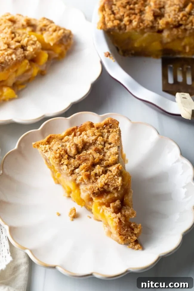 A perfectly baked peach crumble pie, cooling on a wire rack.