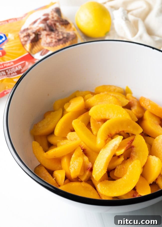 A bowl filled with freshly sliced peaches, ready for the pie filling.