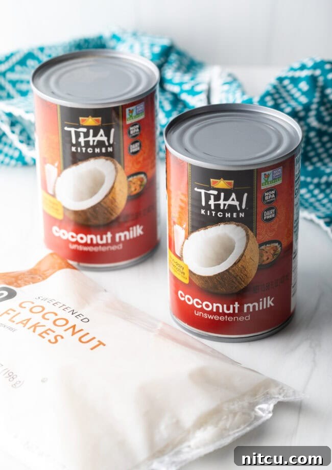 Two cans of unsweetened full-fat coconut milk, the key ingredient for creamy dairy-free popsicles.