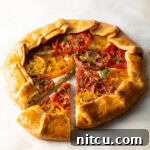 Italian Tomato Pie, a savory galette with flaky crust, goat cheese, and heirloom tomatoes