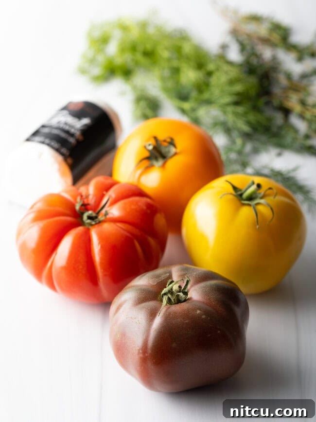 Four multicolored heirloom tomatoes displayed, showing their vibrant range of colors.