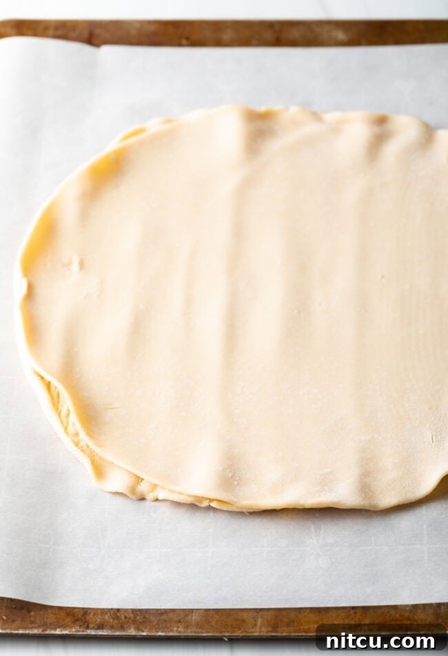 Step-by-step image of pie crust being rolled out on a parchment-lined baking sheet.