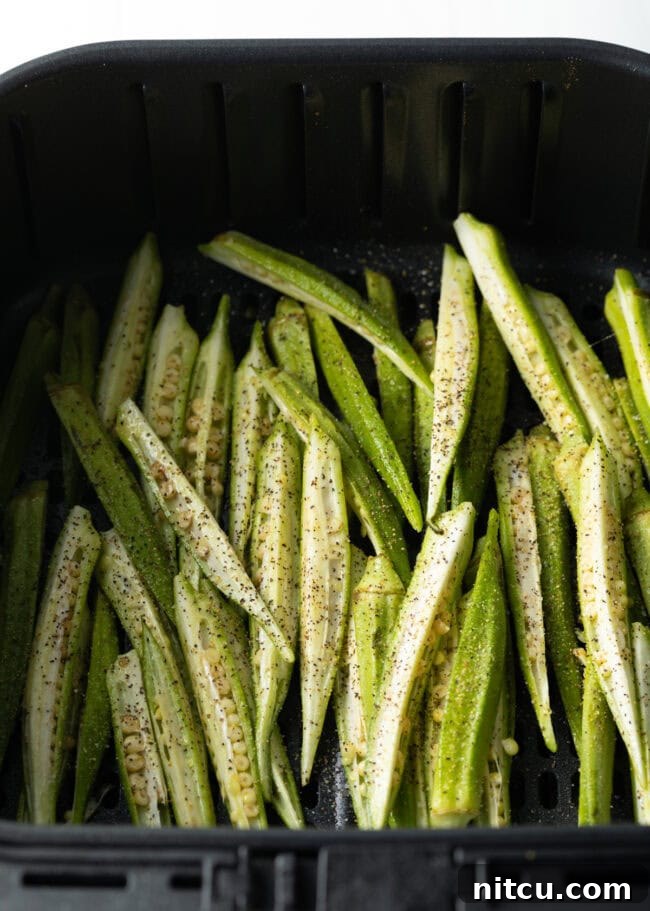 Raw slices of okra in fryer basket.