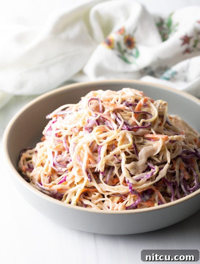 A close-up view of the final Southern Coleslaw dish, showing its creamy texture and vibrant ingredients.
