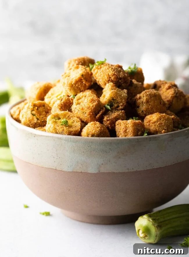 Bowl overflowing with crunchy breaded fried okra, ready to be served as a classic Southern side dish.