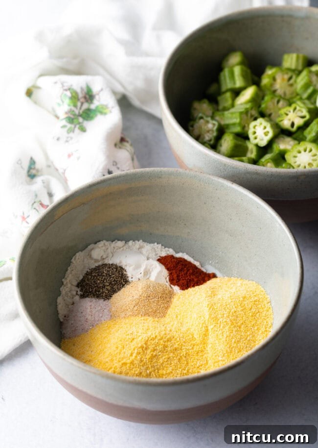A bowl containing a mixture of yellow cornmeal, all-purpose flour, and various spices, prepped for breading.