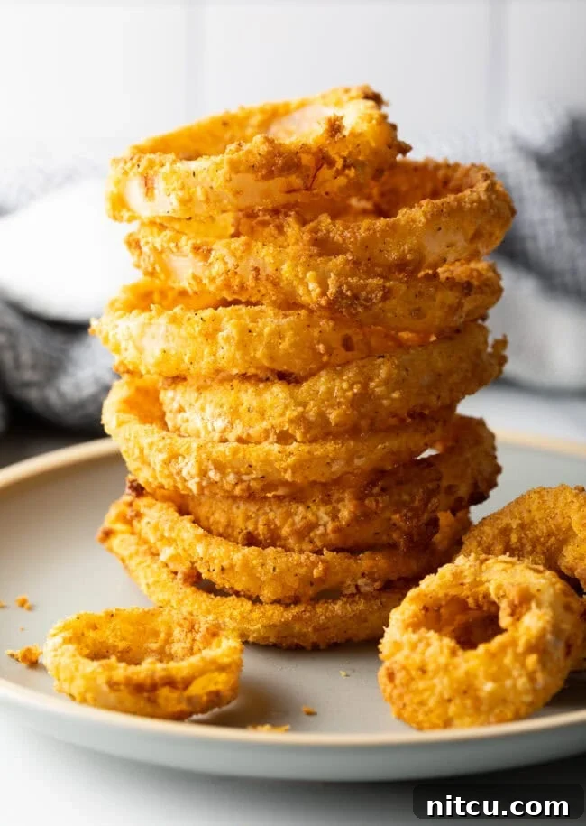Stack of crispy air fried onion rings.
