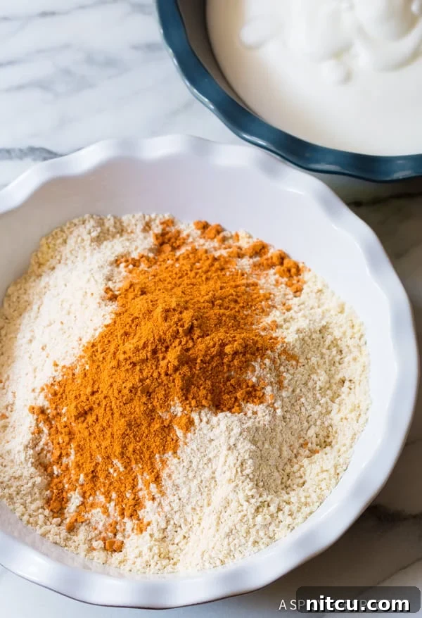 Seasonings for onion rings in a mixing bowl.