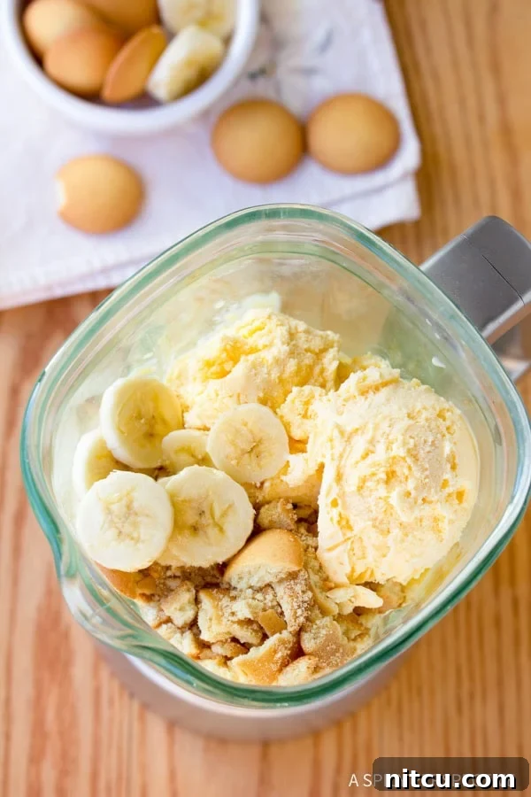 Close-up of the Banana Pudding Milkshake blending process, showing ice cream and bananas