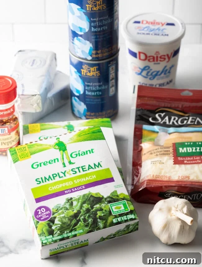 Crockpot Spinach Artichoke Dip Ingredients you need on a white background.