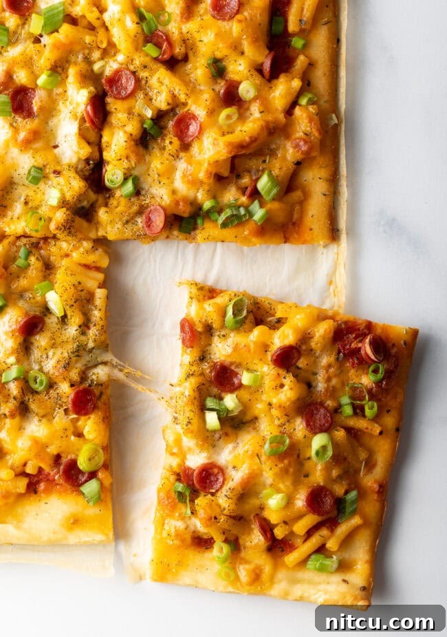 Top down, square piece of pizza being removed.