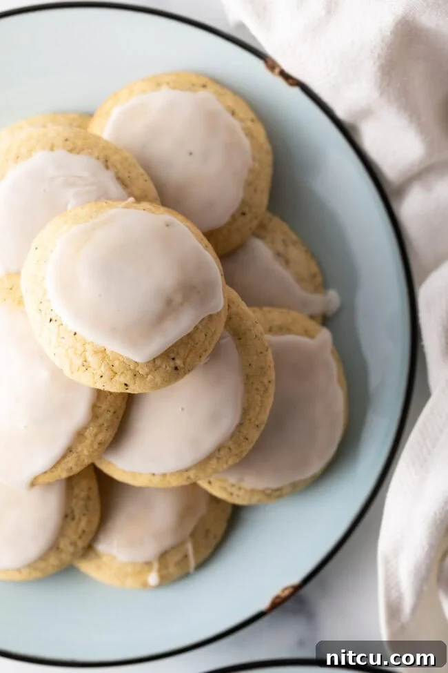 Top-down view of a stack of delicate lemon glazed Earl Grey cookies, ready to be enjoyed.