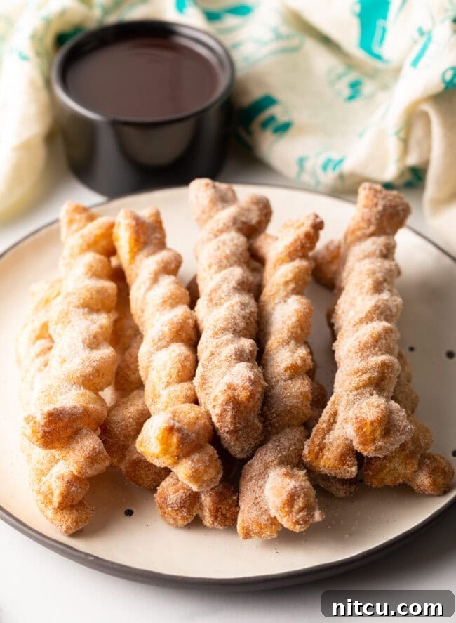 Plate of cinnamon twists stacked on top of each other.