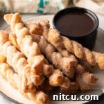 Easy Cinnamon Twists stacked on a plate.
