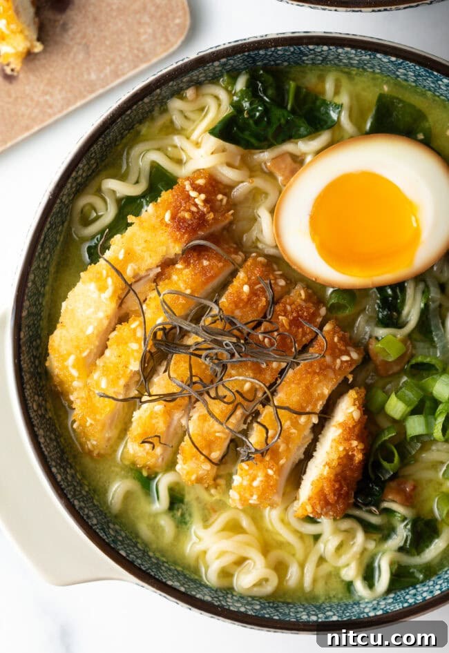 Close view chicken katsu in a bowl of ramen.