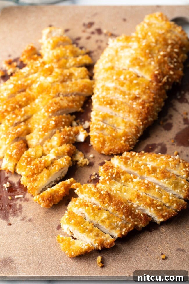Chicken katsu sliced on a cutting board.