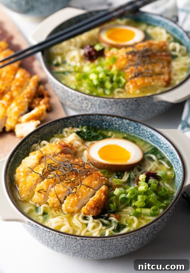 Bowls of ramen noodle soup topped with crispy fried chicken.