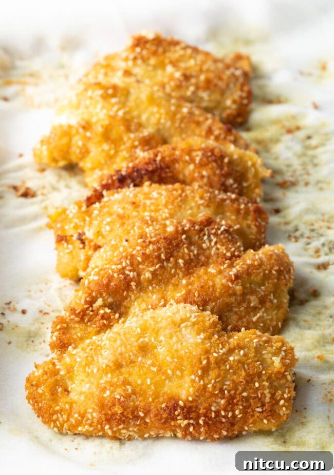 Cooked chicken katsu pieces laid on a paper towel.