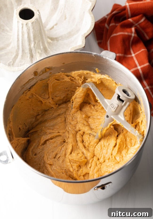 Smooth, blended cake batter in a mixing bowl, ready to be transferred to the prepared Bundt pan.