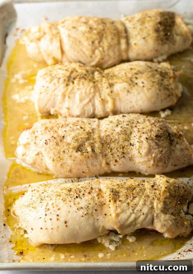 Baked roulade, cooked to perfection and still wrapped on a baking sheet, showcasing golden-brown exterior.