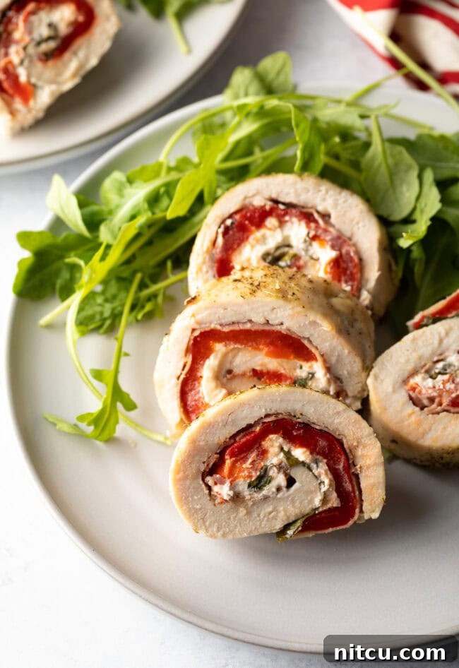 Beautifully plated chicken roulade, ready for serving.