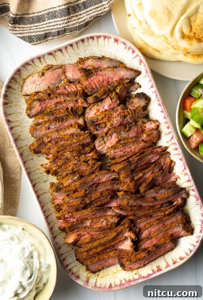 Top down slices of beef shawarma on a serving platter.