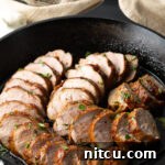 Cooked honey garlic pork tenderloin out from roasted. Chops sliced in cast iron skillet.