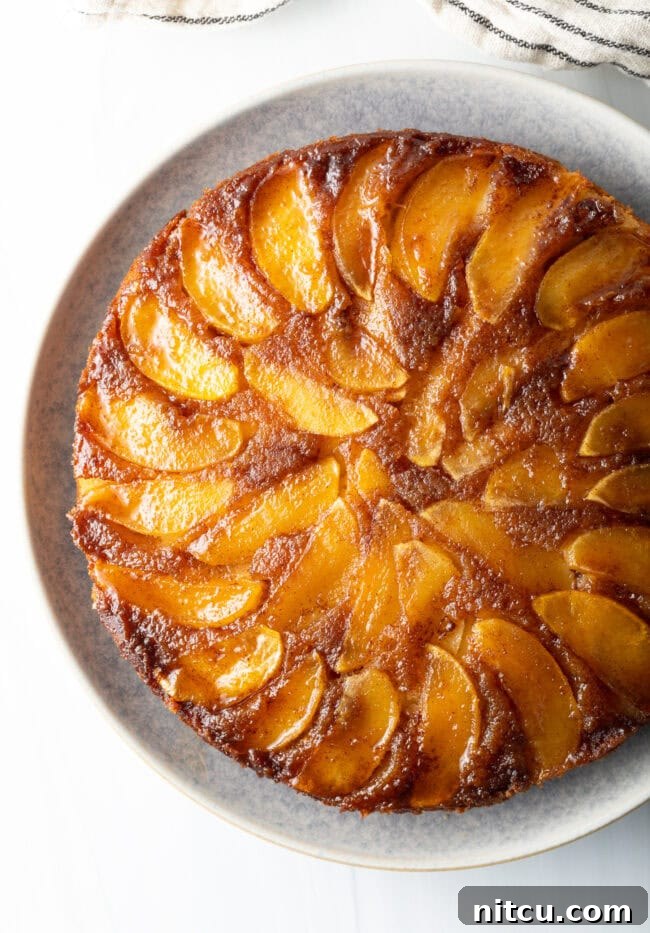 Top down apple upside down cake on a platter.