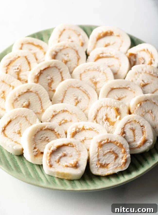 Potato Peanut Butter Candy - Green plate filled with round peanut butter potato candy slices.