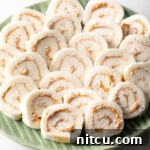 Green plate filled with round peanut butter potato candy slices.