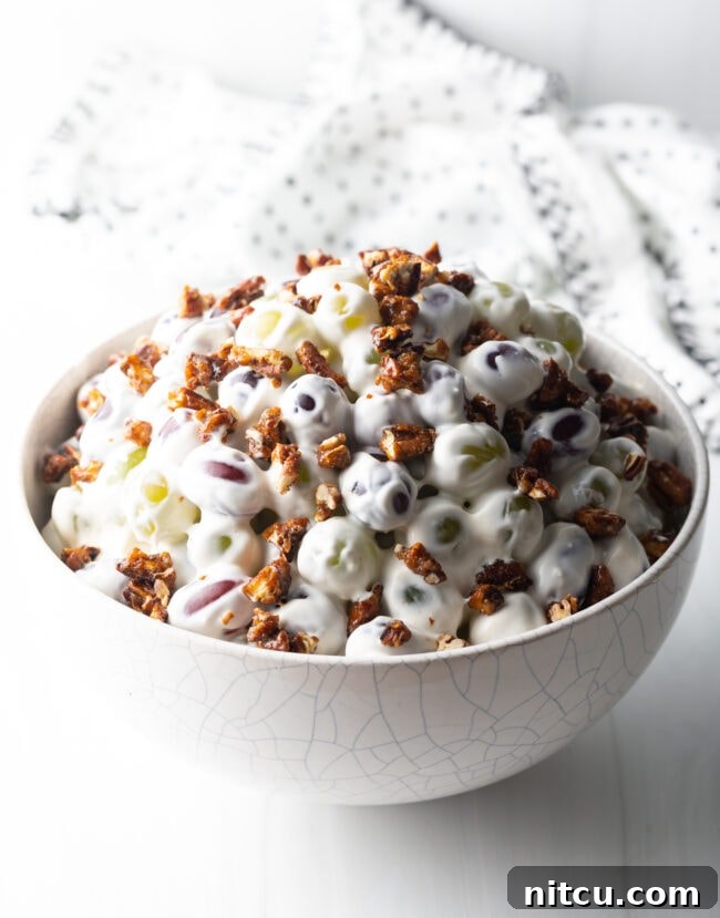 Side view of grape salad in a white bowl.