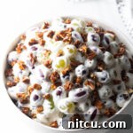 Grape salad in a white bowl.