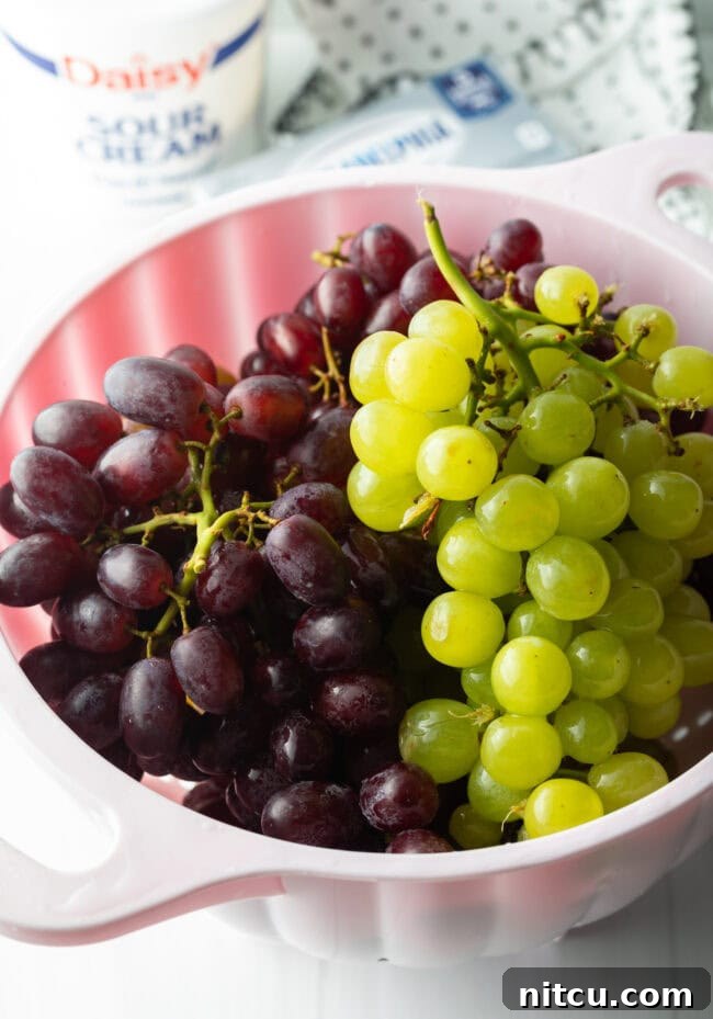 Green bunch and red bunch in a large white bowl.