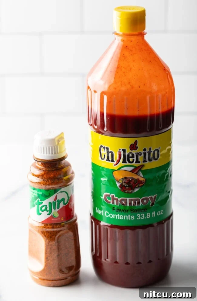 Bottle of chamoy sauce and smaller bottle of Tajin seasoning, ready for mixing.