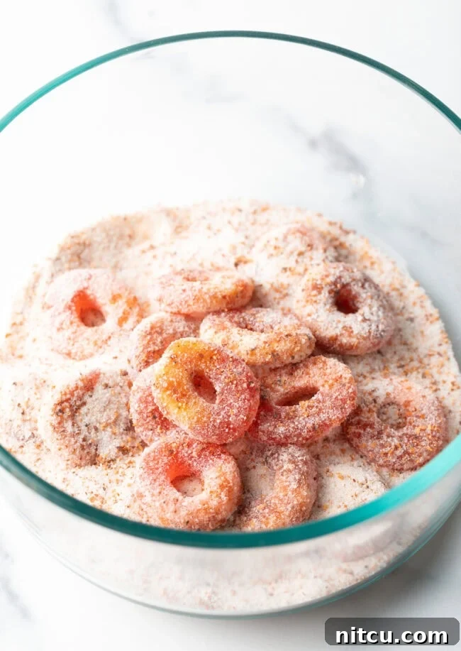 Close view of a pile of Mexican chamoy candy gummy rings, now fully coated in sugar and glistening.