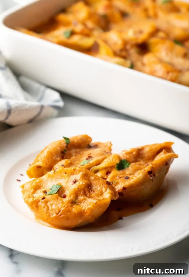 Serving of cheesy seafood pasta on a white plate.