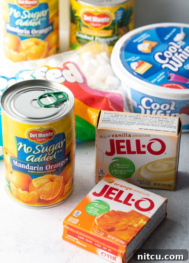 Ingredients you need for Orange Fluff: Can of mandarin orange slices, box of jello pudding and jello gelatin, container of cool whip, bag of mini marshmallows.