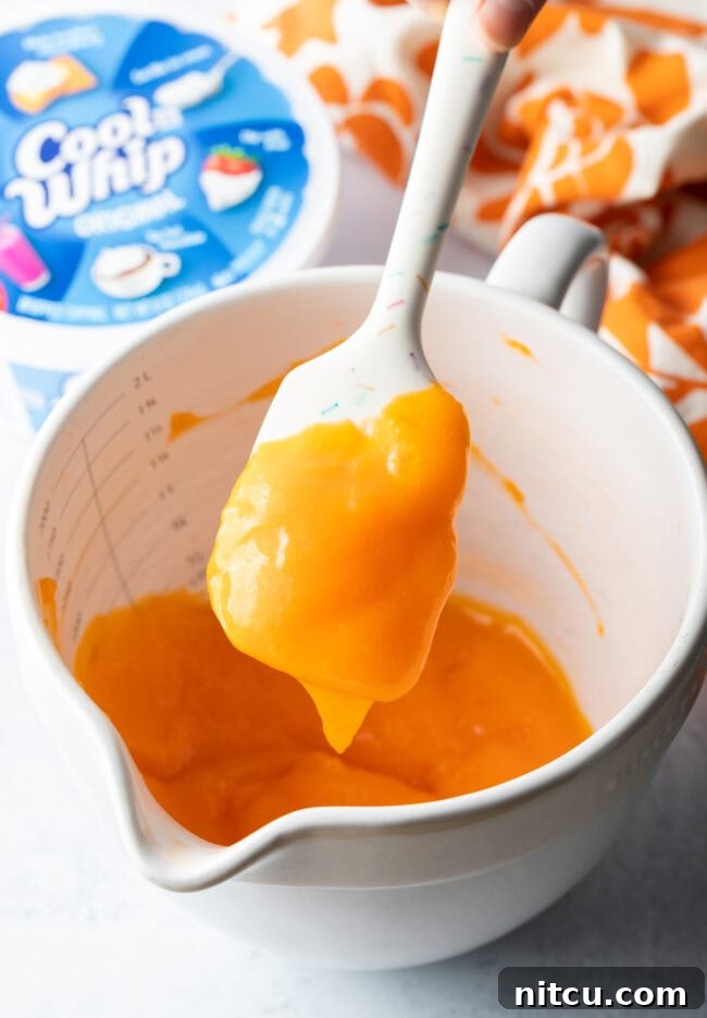 Pudding and jello mix combined in a white bowl.