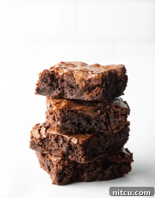 Stack of 4 brownies on a white background from homemade ghirardelli brownie mix.