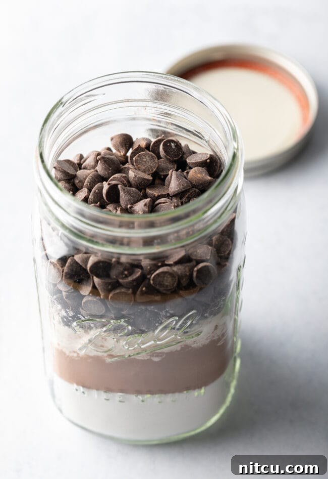 Topping the jar of homemade brownie mix with chocolate chips.