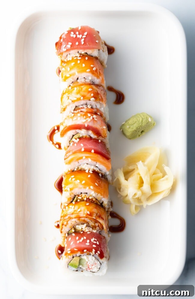 Sushi roll on a white rectangle plate, drizzled with eel sauce made with 3 ingredients.