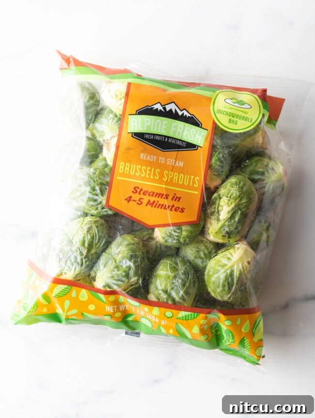 A bag of fresh, whole Brussels sprouts, ready for preparation.