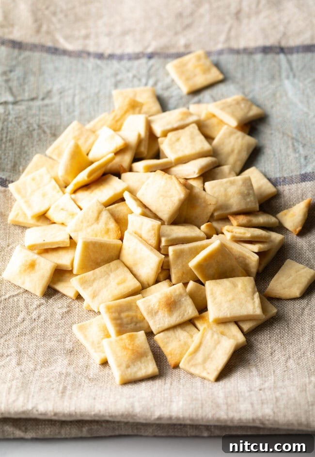 A generous pile of communion bread, perfectly cut into small squares.
