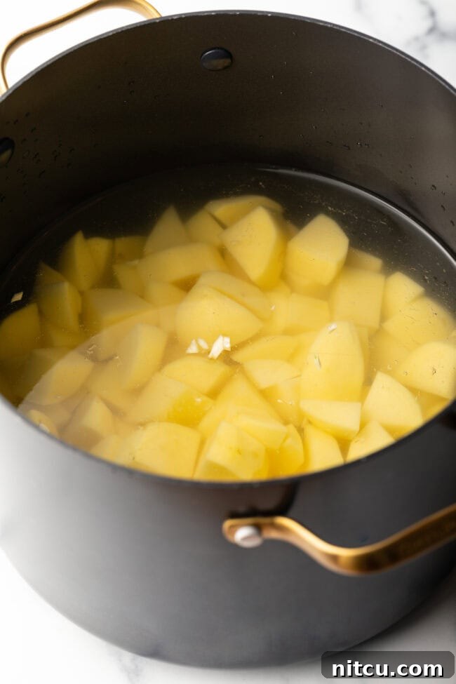 Cooking chopped potatoes in water.