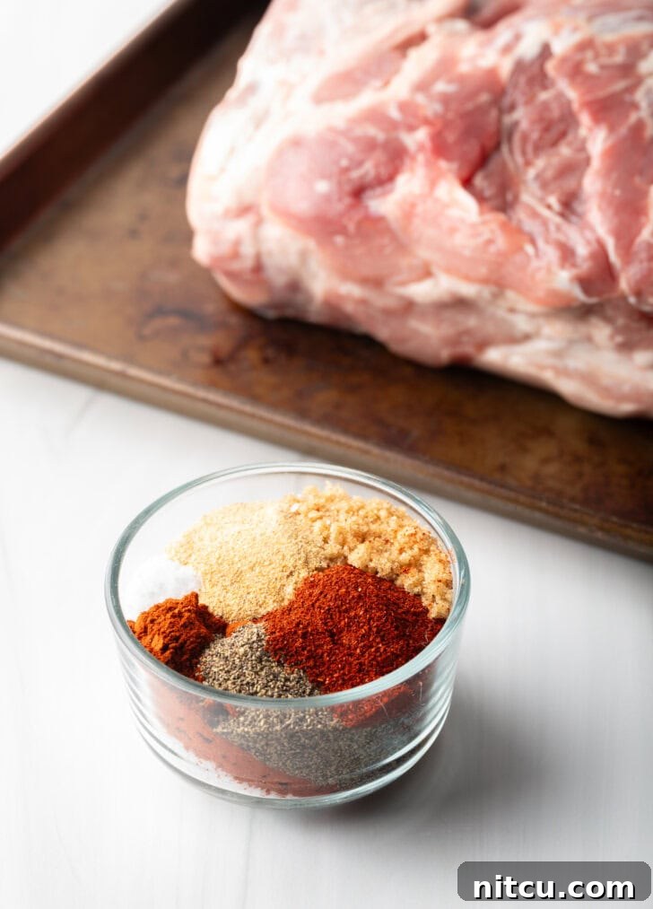 A medley of dry spice rub seasonings, including brown sugar, paprika, and chili powder, perfectly blended in a small glass bowl.