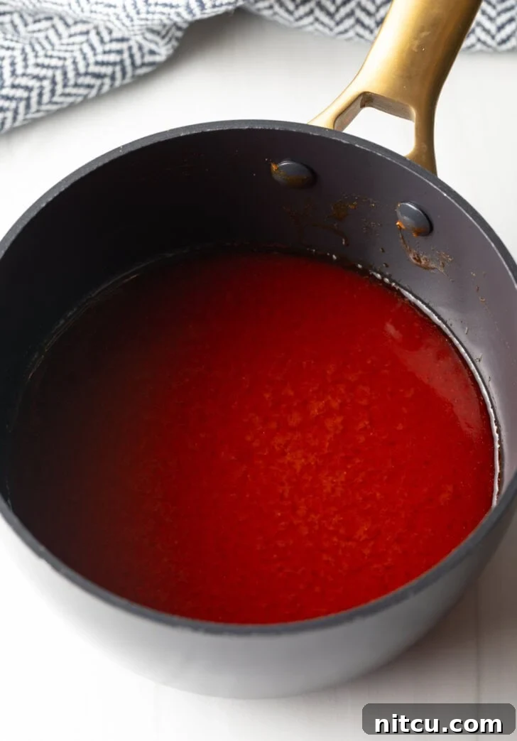Black sauce pot with red wing sauce.