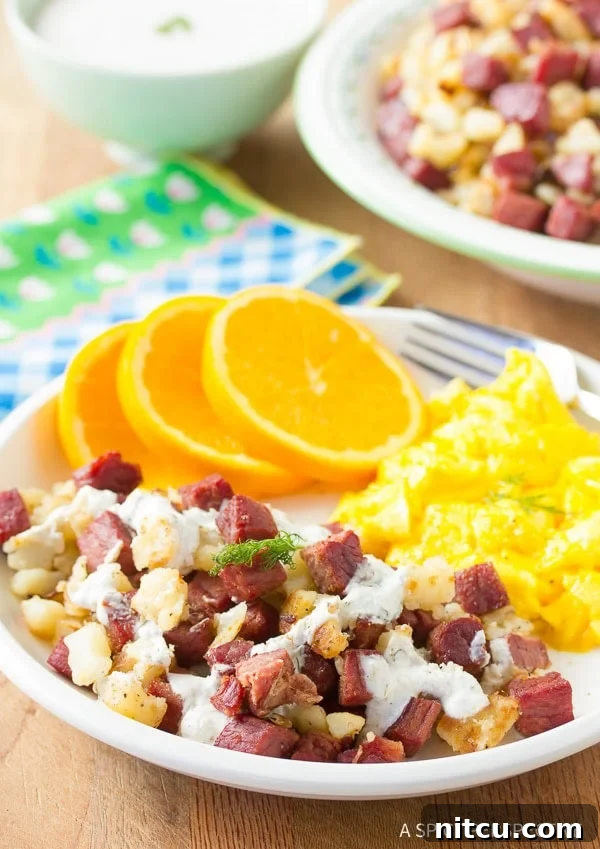 Savory Corned Beef Hash served with a dollop of fresh horseradish cream sauce, ideal for a festive breakfast.